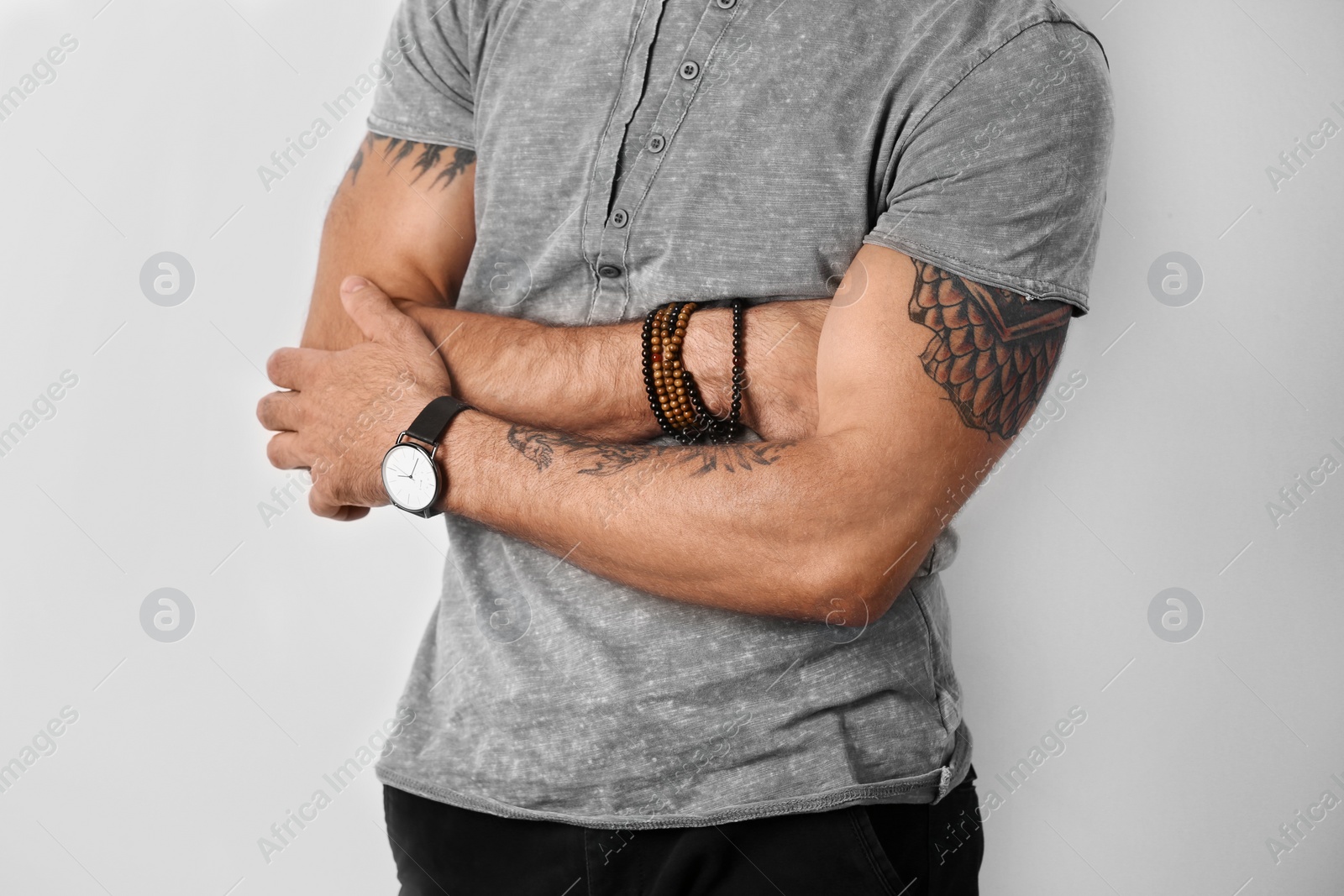 Photo of Closeup view of tattooed man on white background