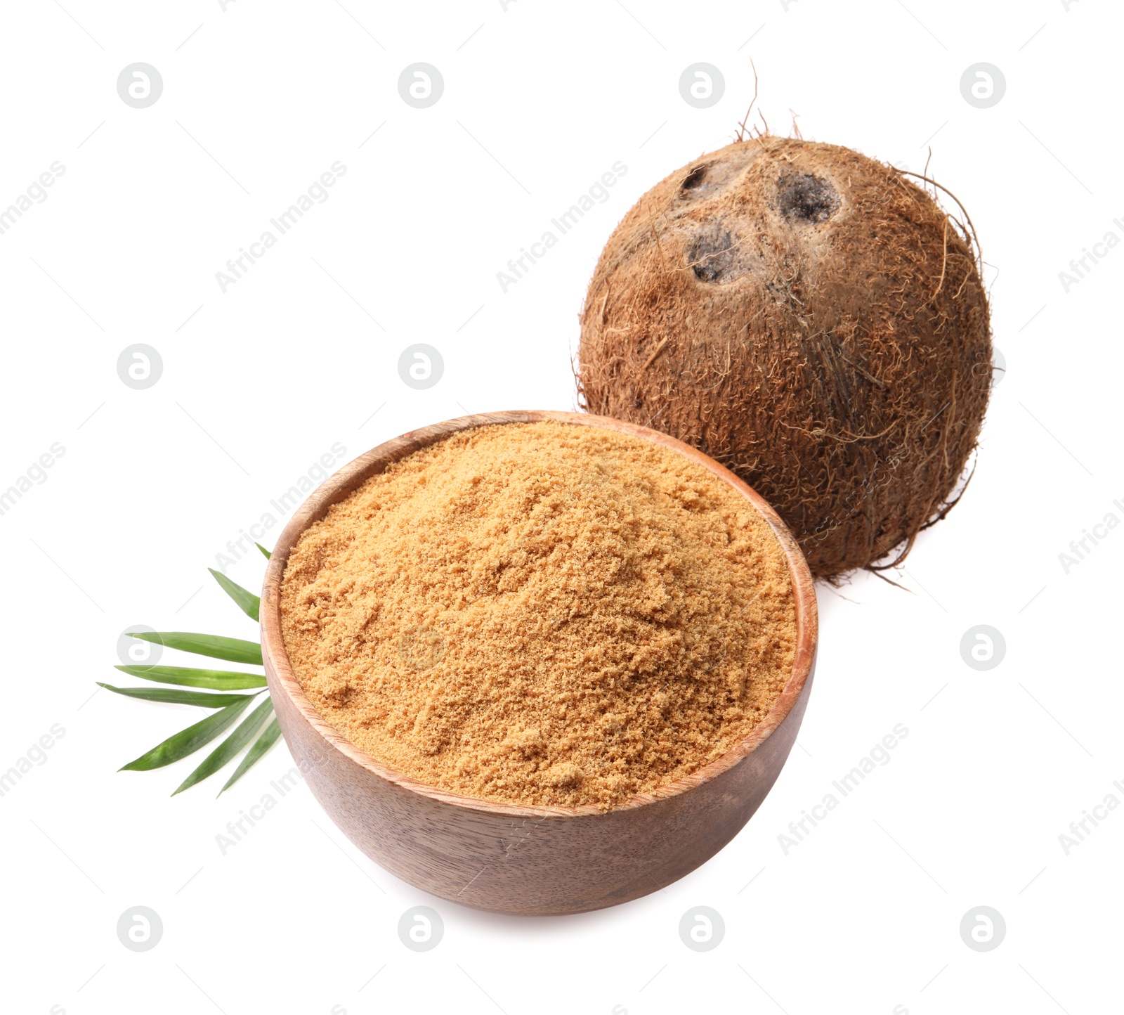 Photo of Coconut sugar in bowl, fruit and palm leaf isolated on white