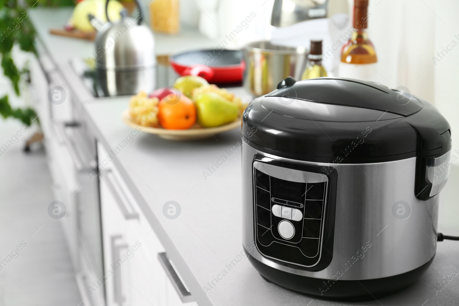 Photo of Modern multi cooker on table in kitchen. Space for text