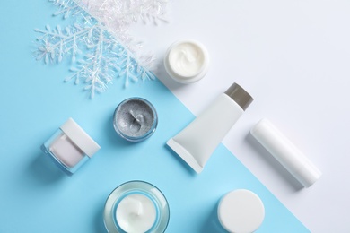 Photo of Set of cosmetic products on color background, flat lay. Winter care