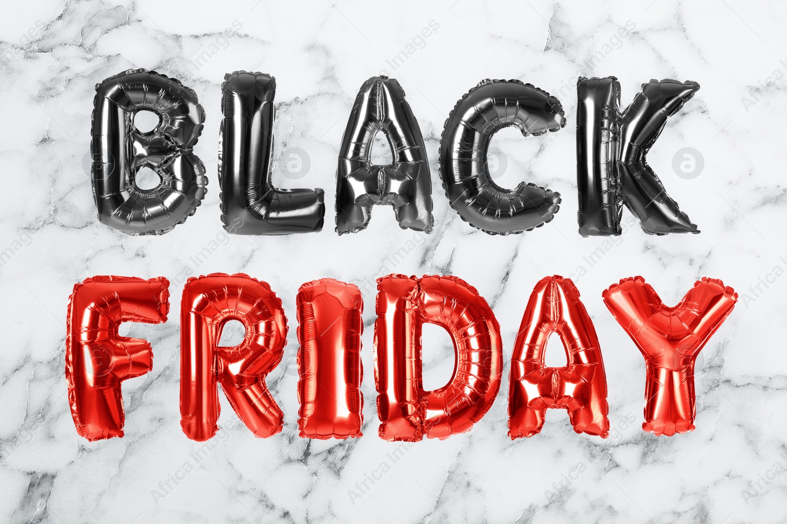 Image of Phrase BLACK FRIDAY made of foil balloon letters on white marble background