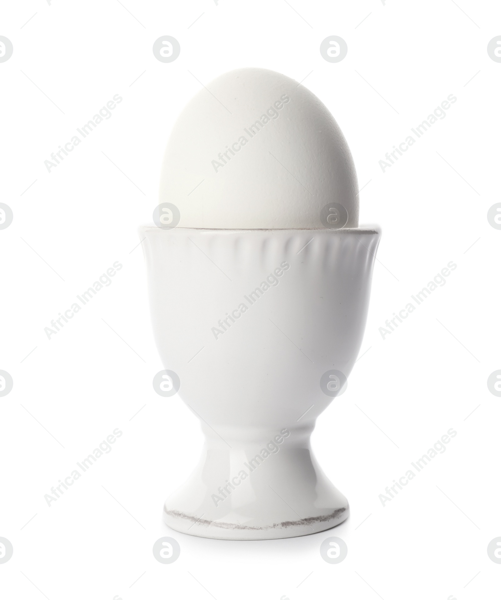 Photo of Holder with boiled egg on white background