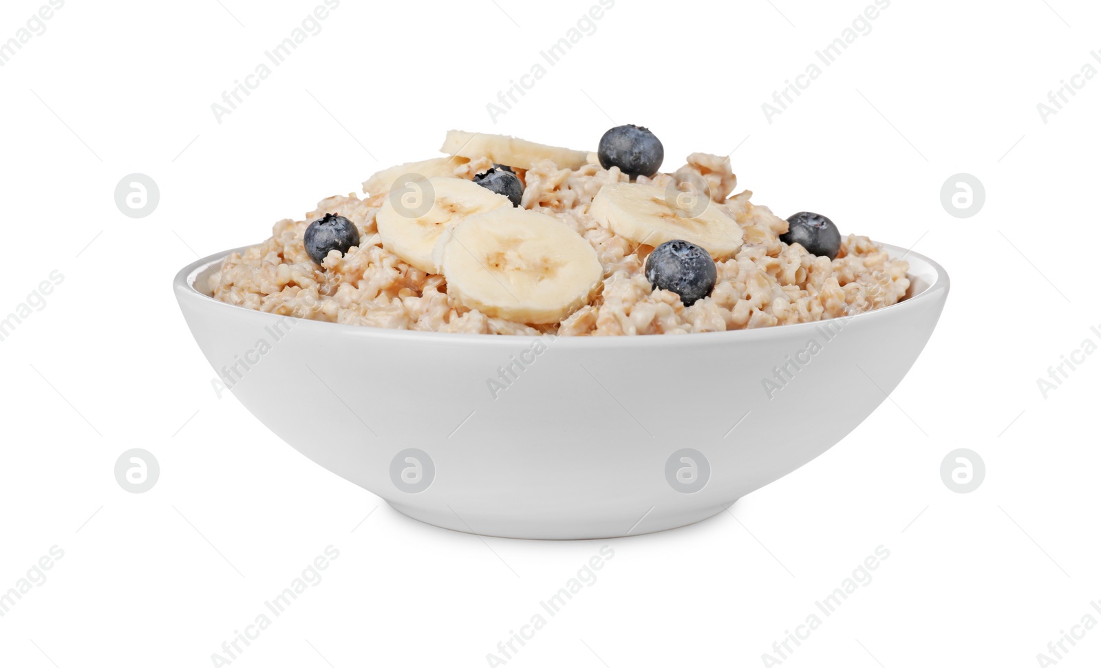 Photo of Tasty boiled oatmeal with blueberries and banana in bowl isolated on white