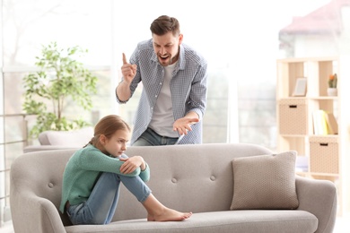 Father arguing with daughter at home
