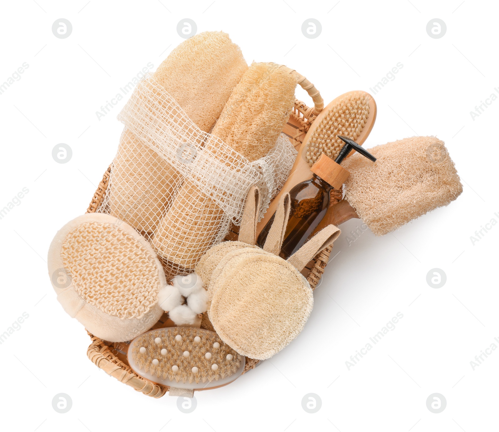 Photo of Set of toiletries with natural loofah sponges in wicker basket isolated on white, top view