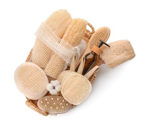 Photo of Set of toiletries with natural loofah sponges in wicker basket isolated on white, top view