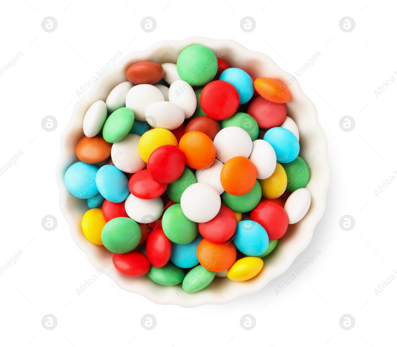 Photo of Bowl with colorful candies isolated on white, top view