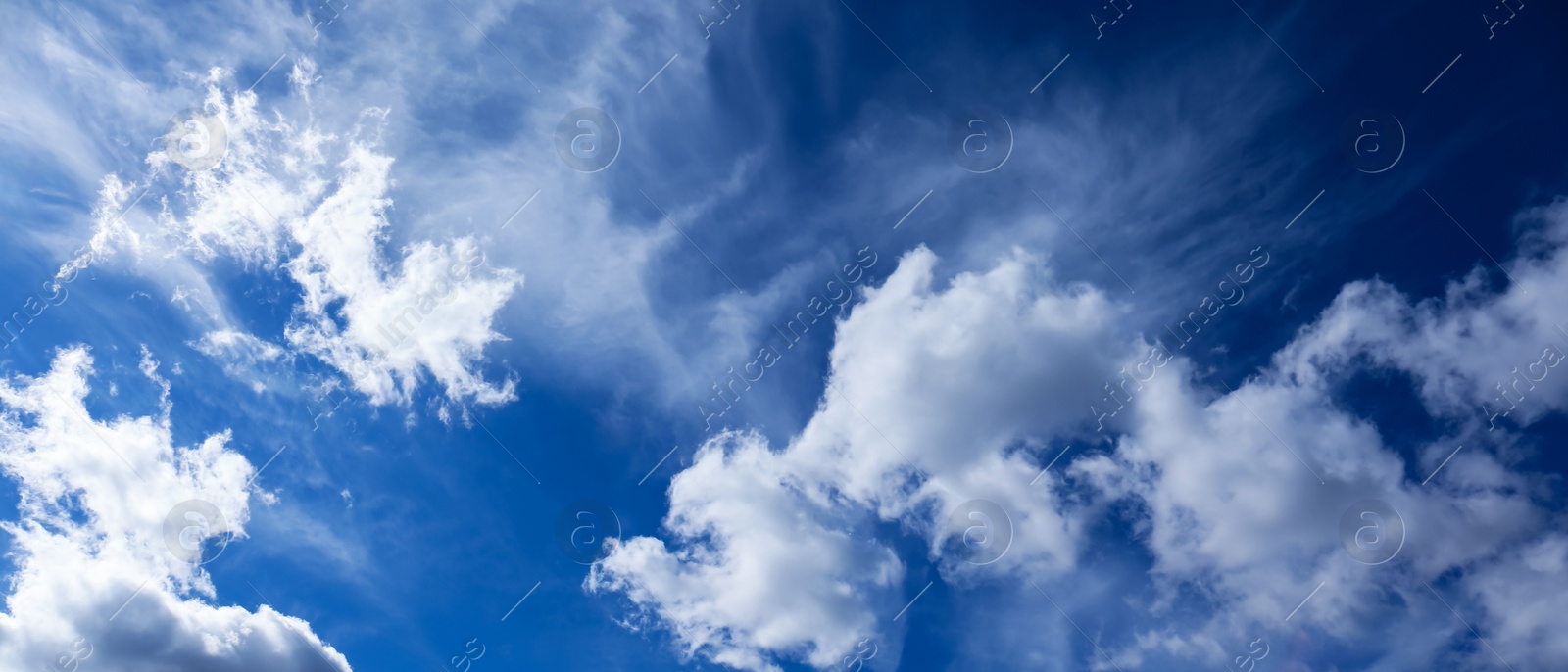 Image of Picturesque view of beautiful blue sky with white clouds on sunny day, banner design