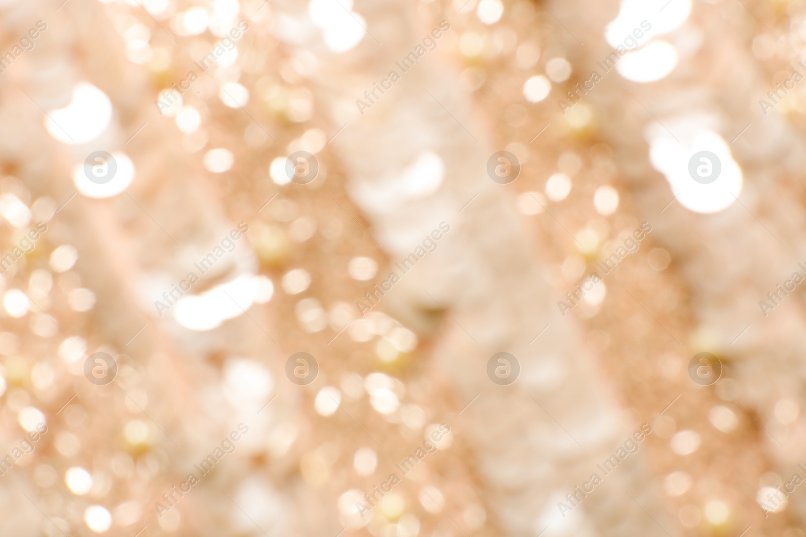Photo of Blurred view of shiny rose gold surface as background
