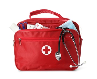Photo of First aid kit with stethoscope on white background