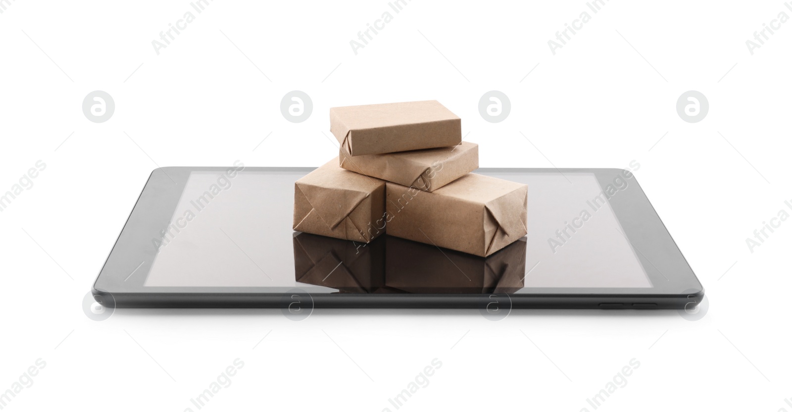 Photo of Internet shopping. Small boxes and modern tablet on white background