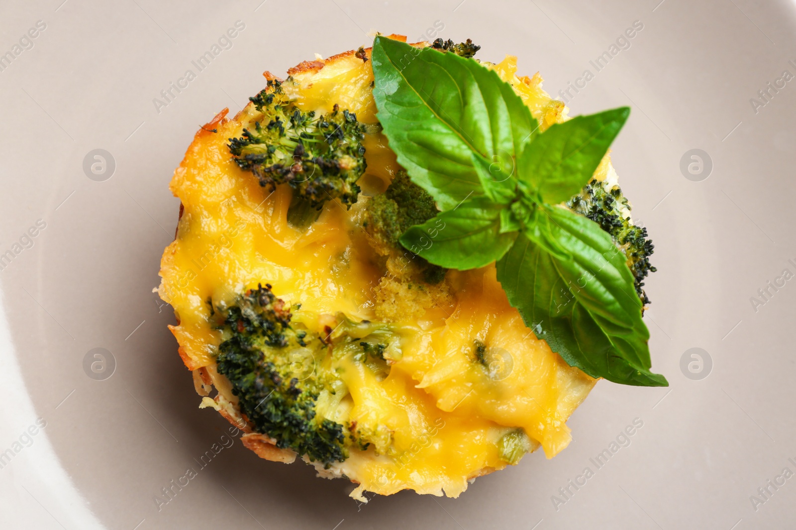 Photo of Top view of tasty broccoli casserole on plate