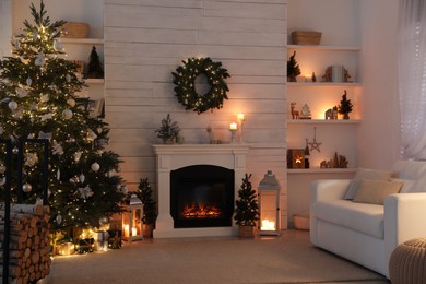 Stylish living room interior with decorated Christmas tree and comfortable sofa