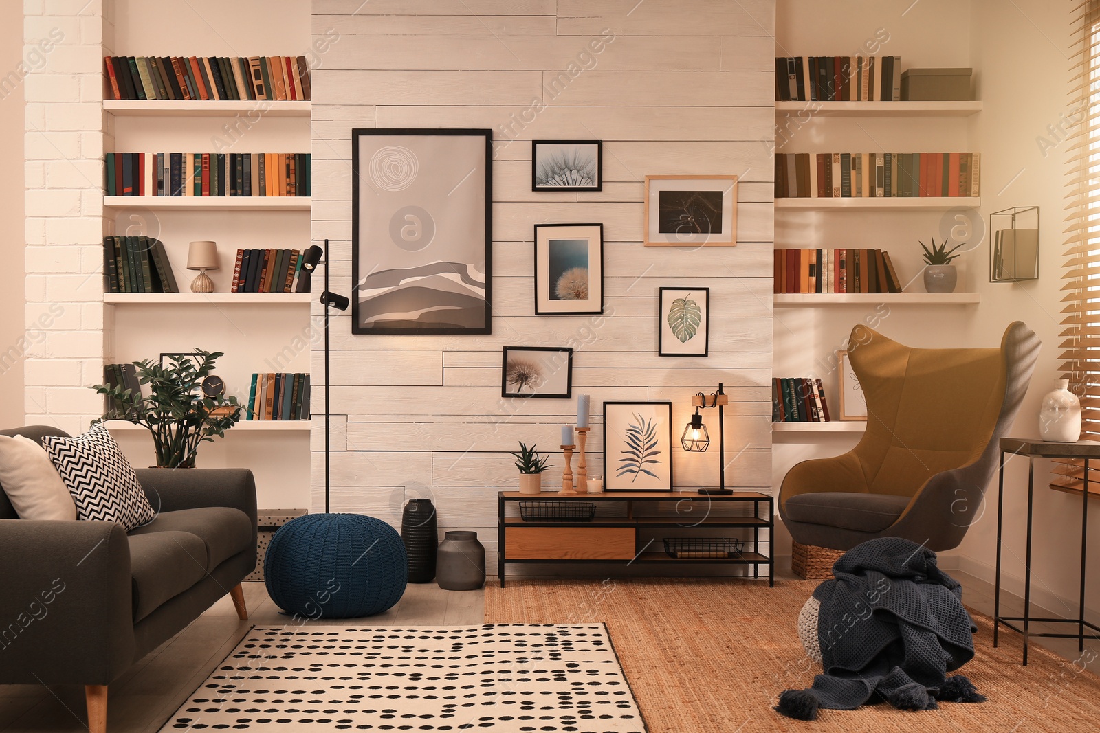 Photo of Cozy home library interior with comfortable furniture and collection of different books on shelves