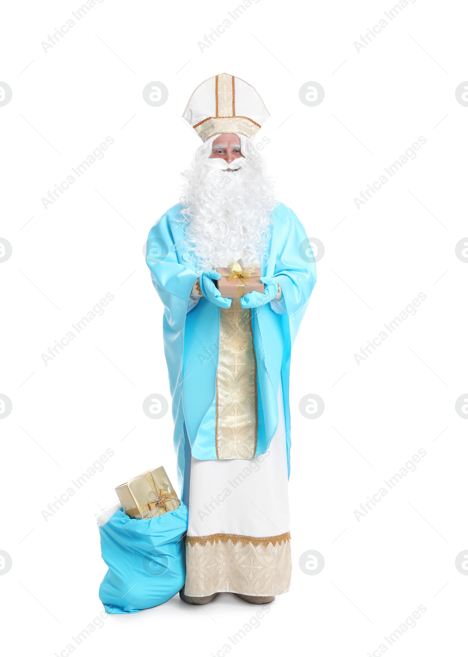 Photo of Full length portrait of Saint Nicholas near sack with presents on white background