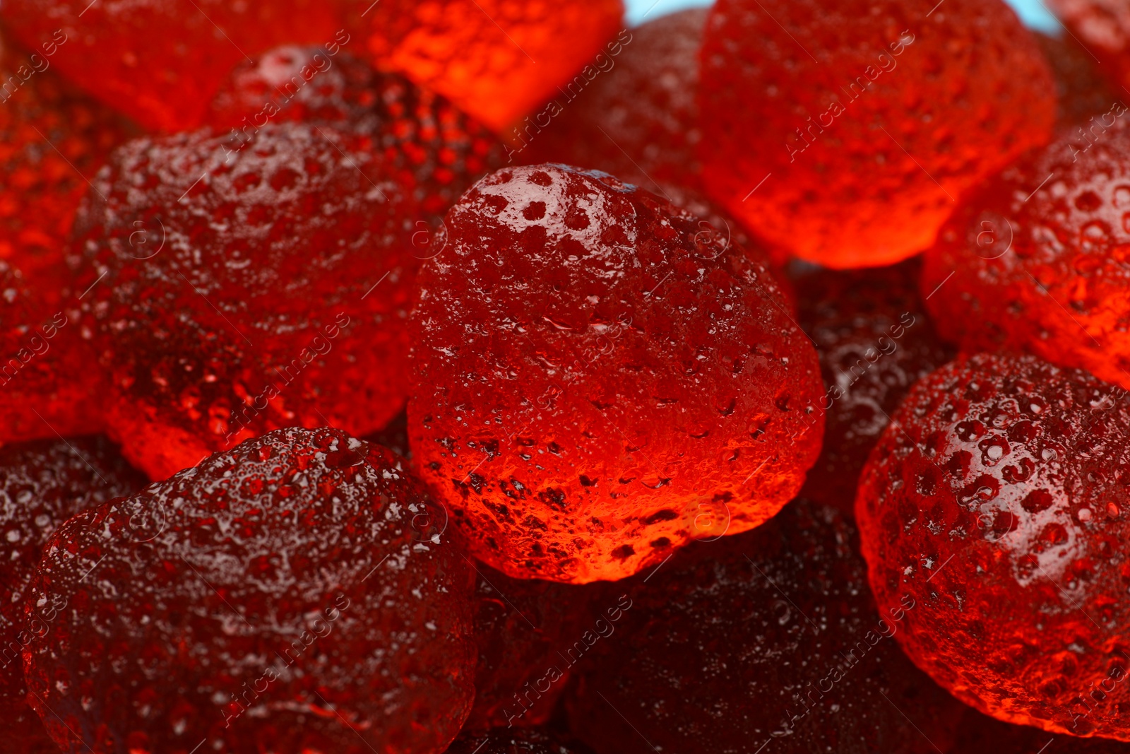 Photo of Delicious gummy strawberry candies as background, closeup