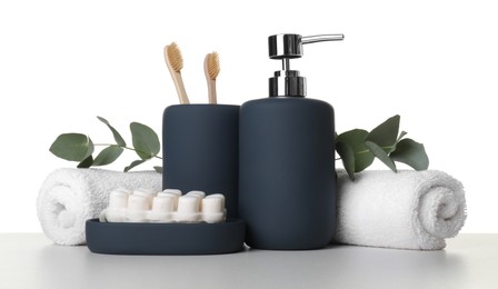 Bath accessories. Different personal care products and eucalyptus branches on table against white background