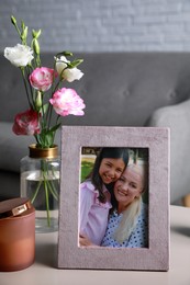 Photo of Framed family photo on light table in living room