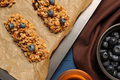 Photo of Making granola bars. Baking tray and ingredients on table, flat lay