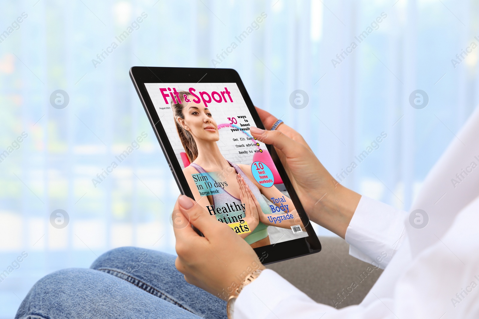 Photo of Woman reading online magazine on tablet indoors, closeup