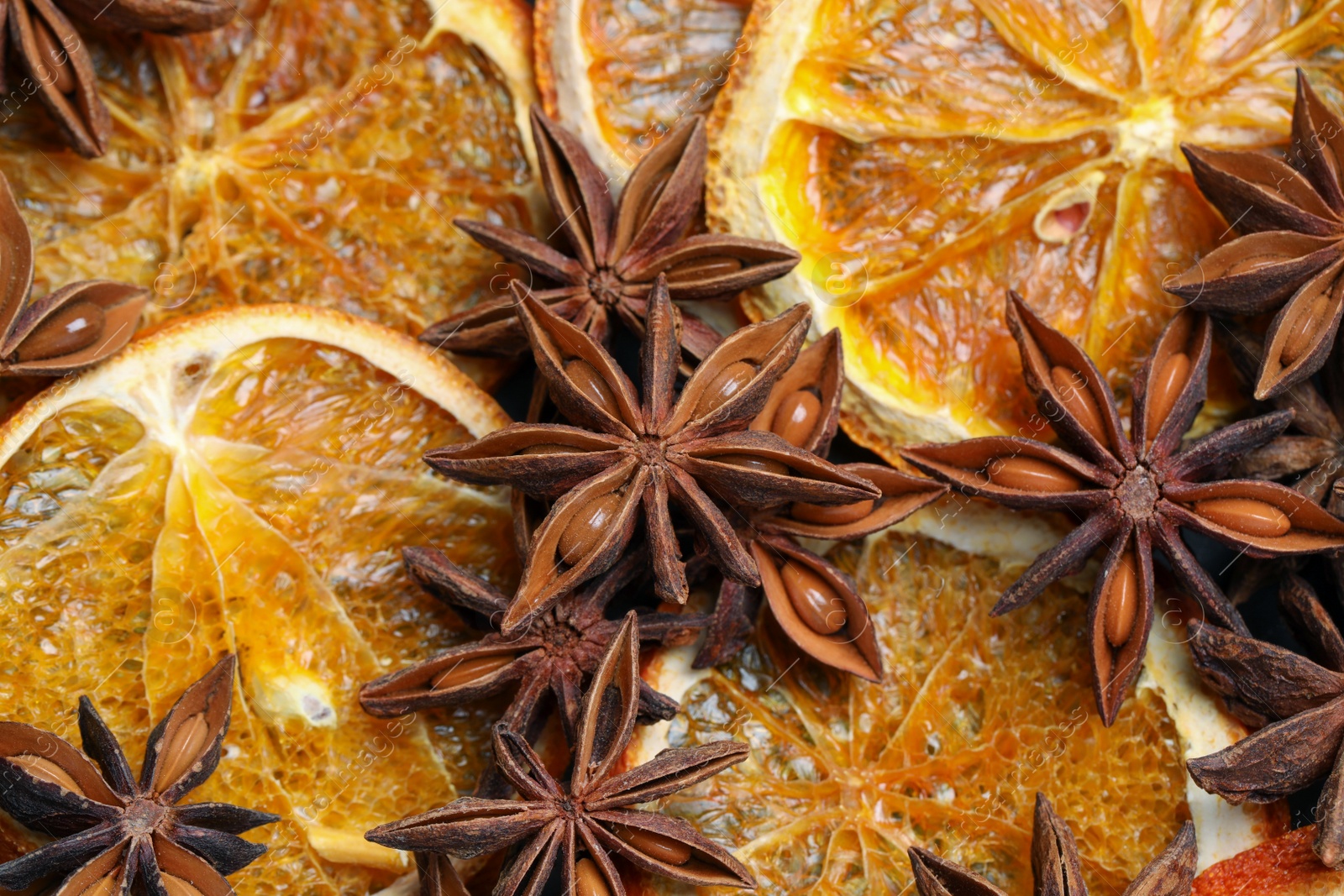 Photo of Dry orange slices and anise stars as background, closeup