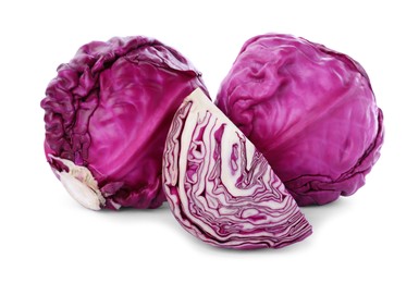 Whole and cut red cabbages on white background