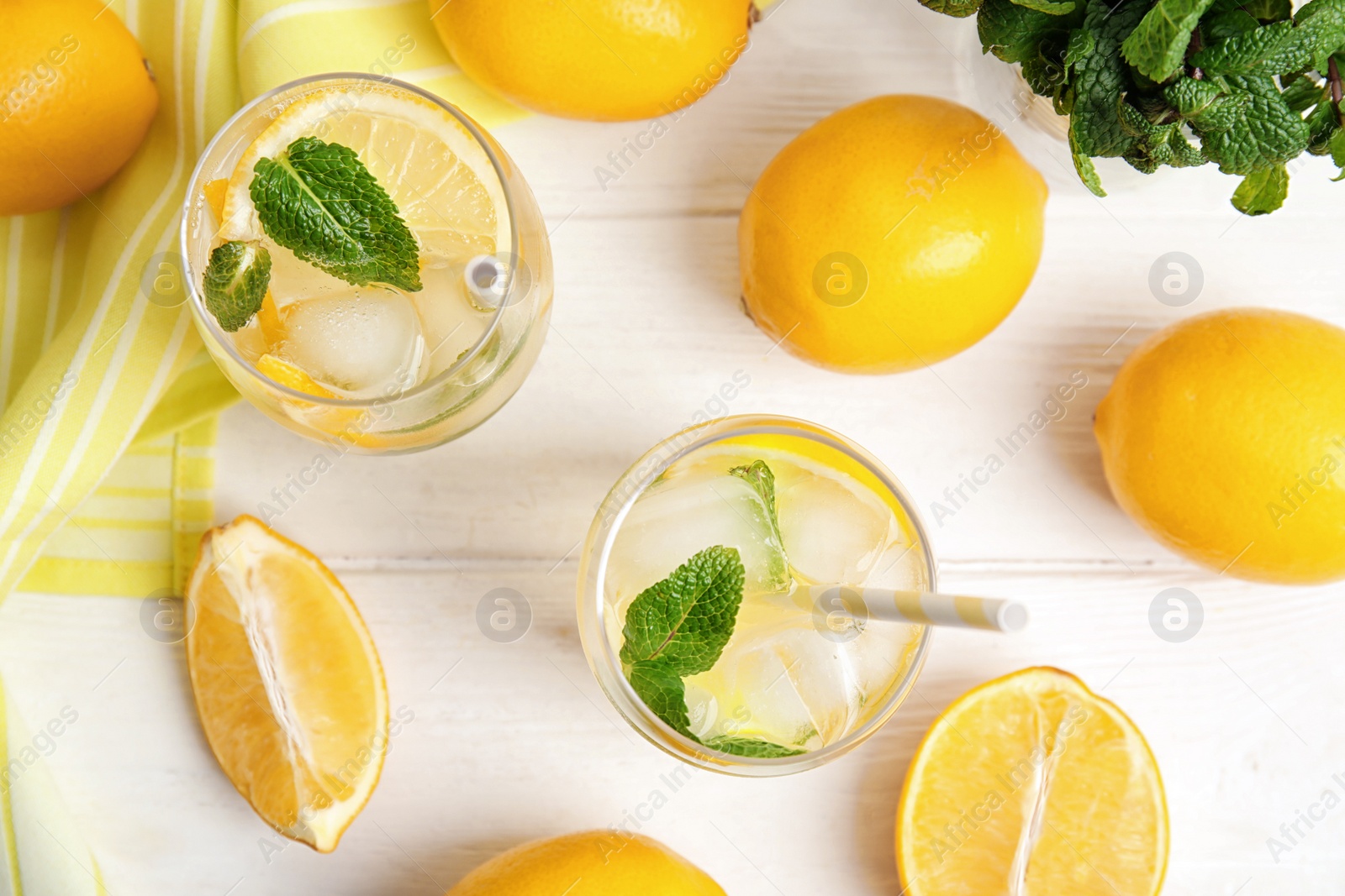 Photo of Cool freshly made lemonade and fruits on white wooden table, flat lay