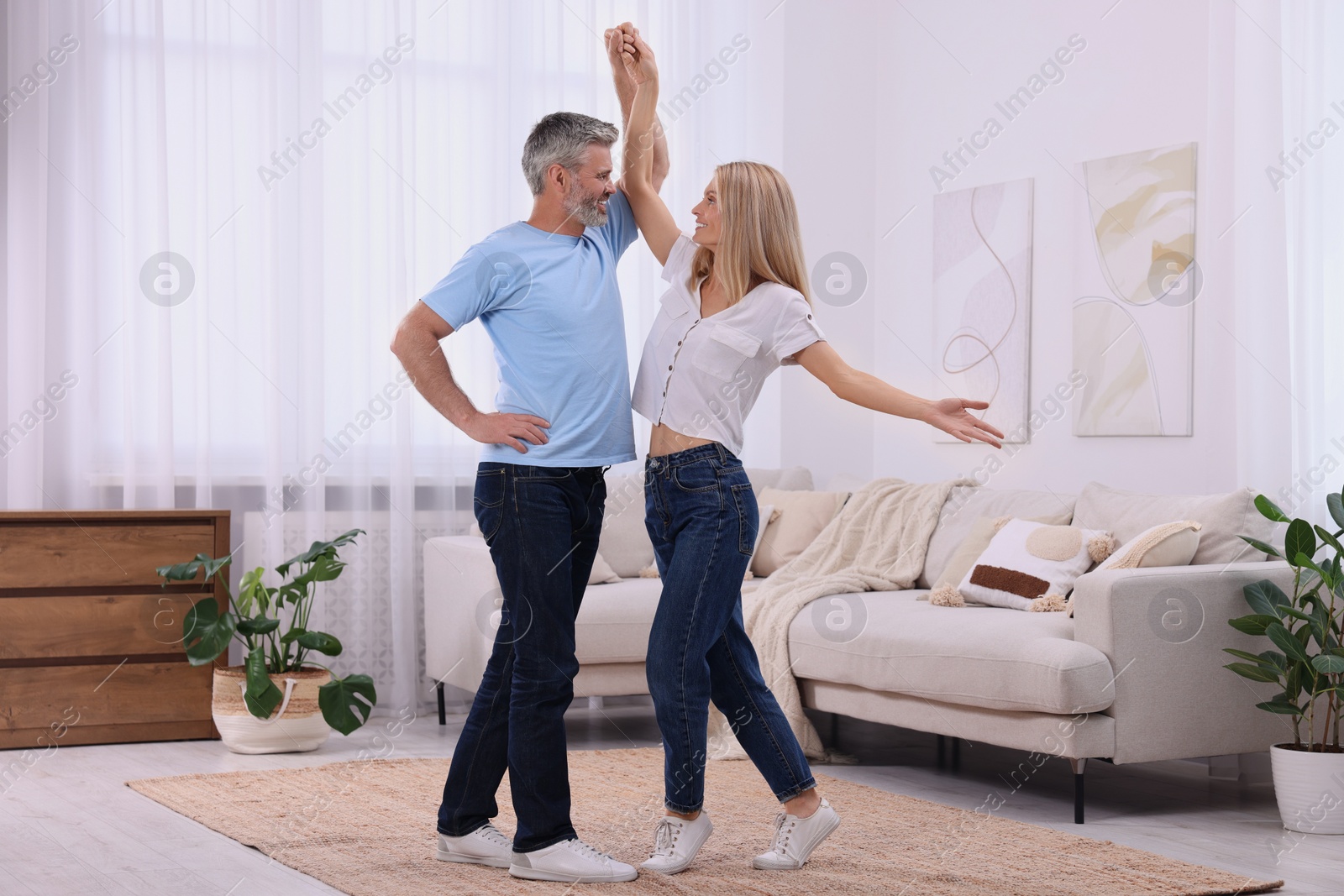 Photo of Happy affectionate couple dancing at home. Romantic date