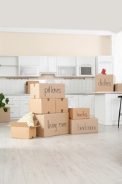 Photo of Many cardboard boxes in kitchen. Moving day