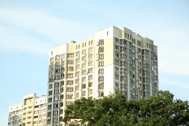 Photo of Exterior of beautiful building with many windows against blue sky