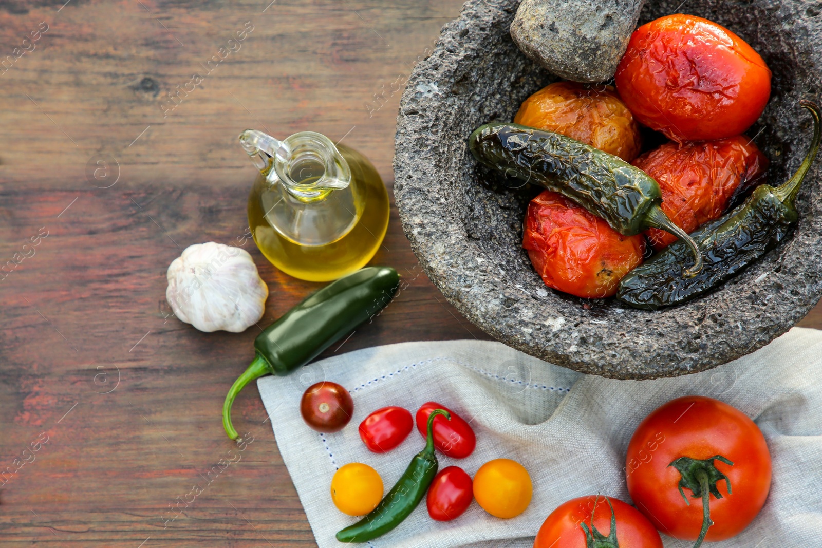 Photo of Ingredients for tasty salsa sauce, pestle and mortar on wooden table, flat lay. Space for text