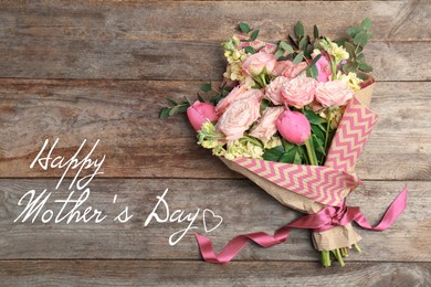 Image of Happy Mother's Day. Bouquet of beautiful flowers on wooden background, top view