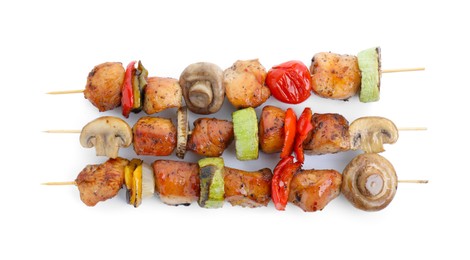 Photo of Delicious shish kebabs with mushrooms, tomato and zucchini isolated on white, top view