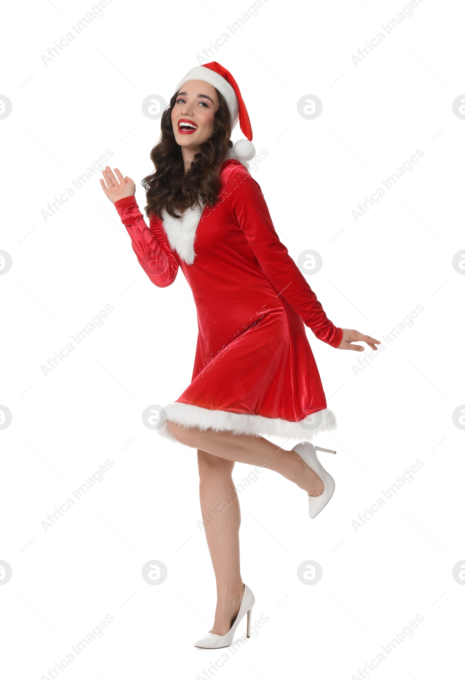 Photo of Beautiful young woman in Christmas red dress and Santa hat isolated on white