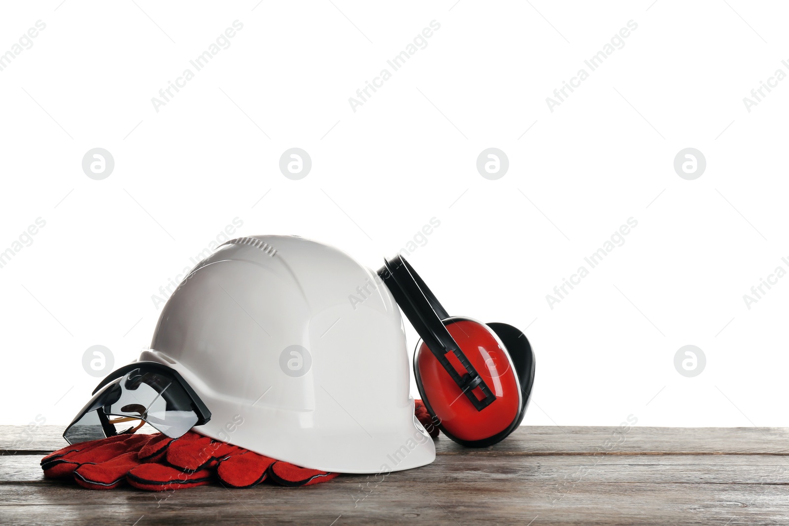 Photo of Set of safety equipment on table against white background
