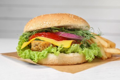 Delicious burger with tofu and fresh vegetables on white table, closeup