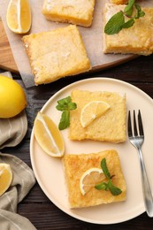 Photo of Tasty lemon bars served on wooden table, flat lay