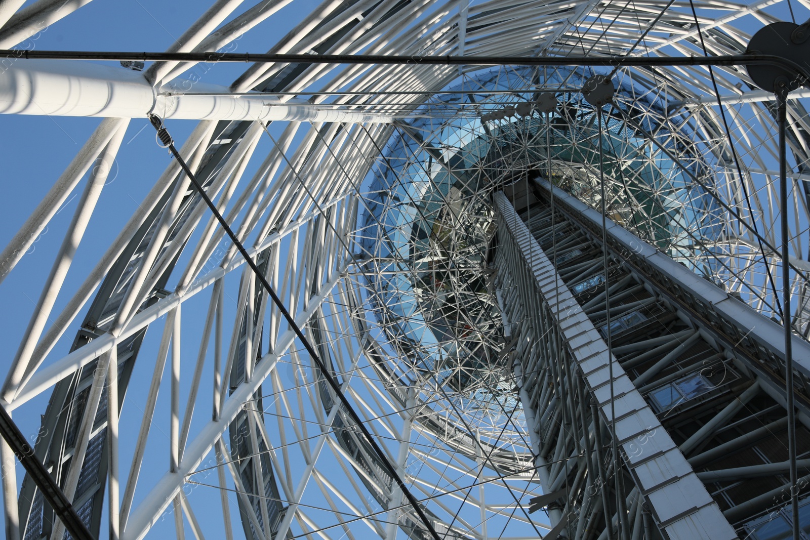 Photo of Structure of modern tower against blue sky, bottom view