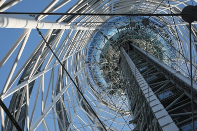 Photo of Structure of modern tower against blue sky, bottom view