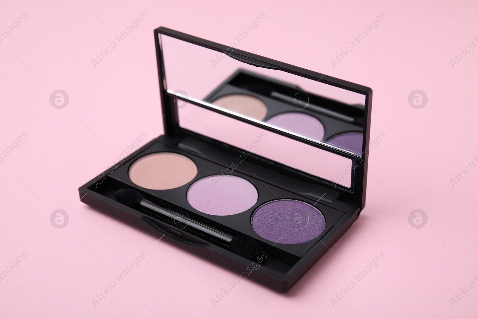 Photo of Beautiful eye shadow palette and brush on pink background