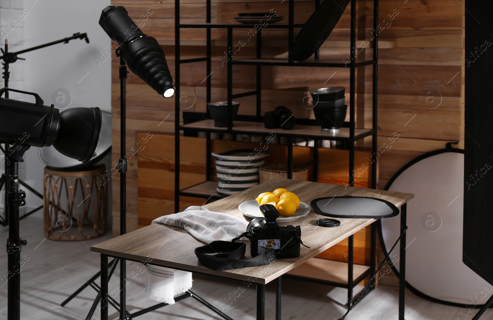 Photo of Professional equipment and many lemons on table in studio. Food photo