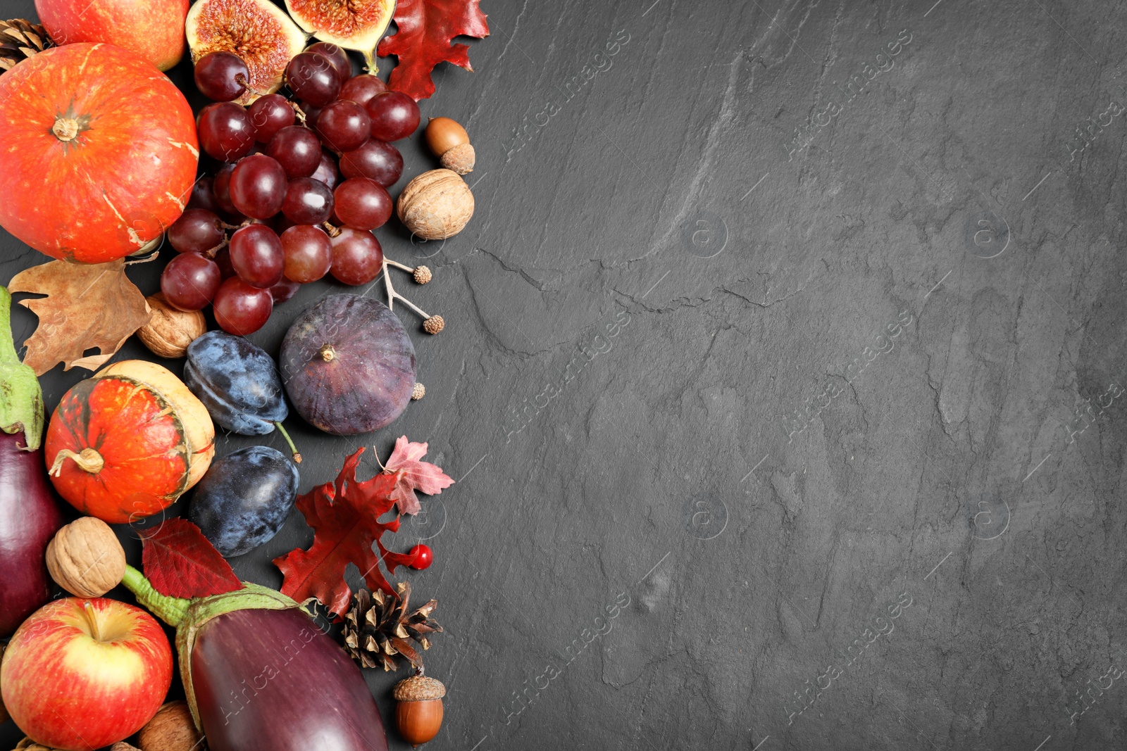 Photo of Flat lay composition with autumn vegetables and fruits on grey background, space for text. Happy Thanksgiving day