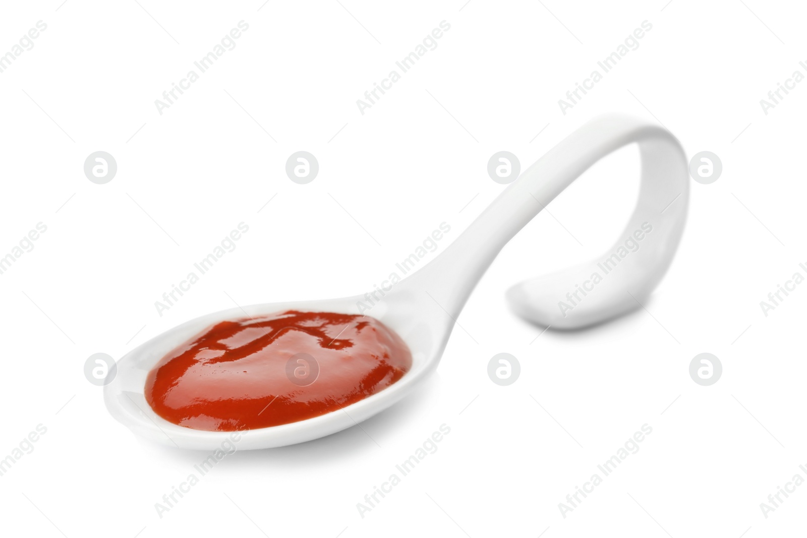 Photo of Spoon with spicy chili sauce on white background