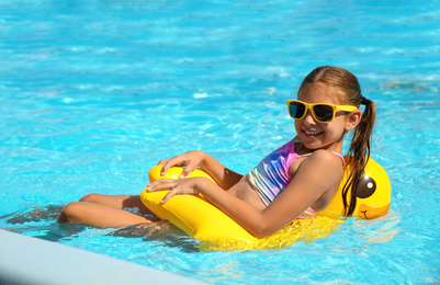 Photo of Happy girl in swimming pool on sunny day