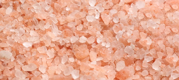 Photo of Pink himalayan salt as background, closeup view