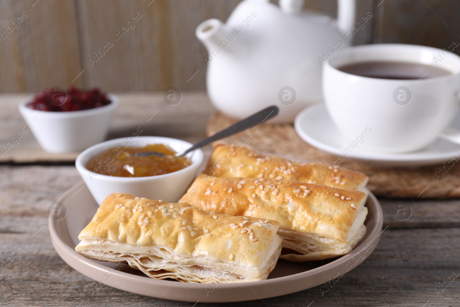 Photo of Delicious puff pastry served on wooden table