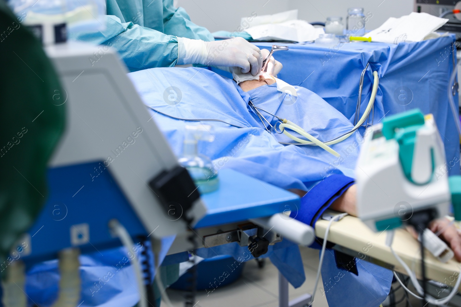 Photo of Professional doctor performing 
frontal sinus trephination in surgery room, closeup