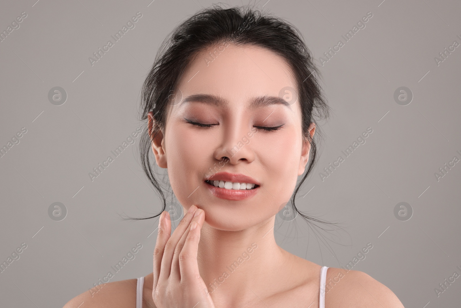 Photo of Portrait of beautiful woman on grey background