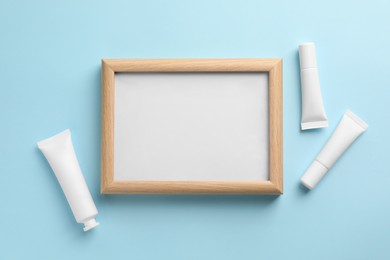 Photo of Blank white board with cosmetics on turquoise background, flat lay. Space for text
