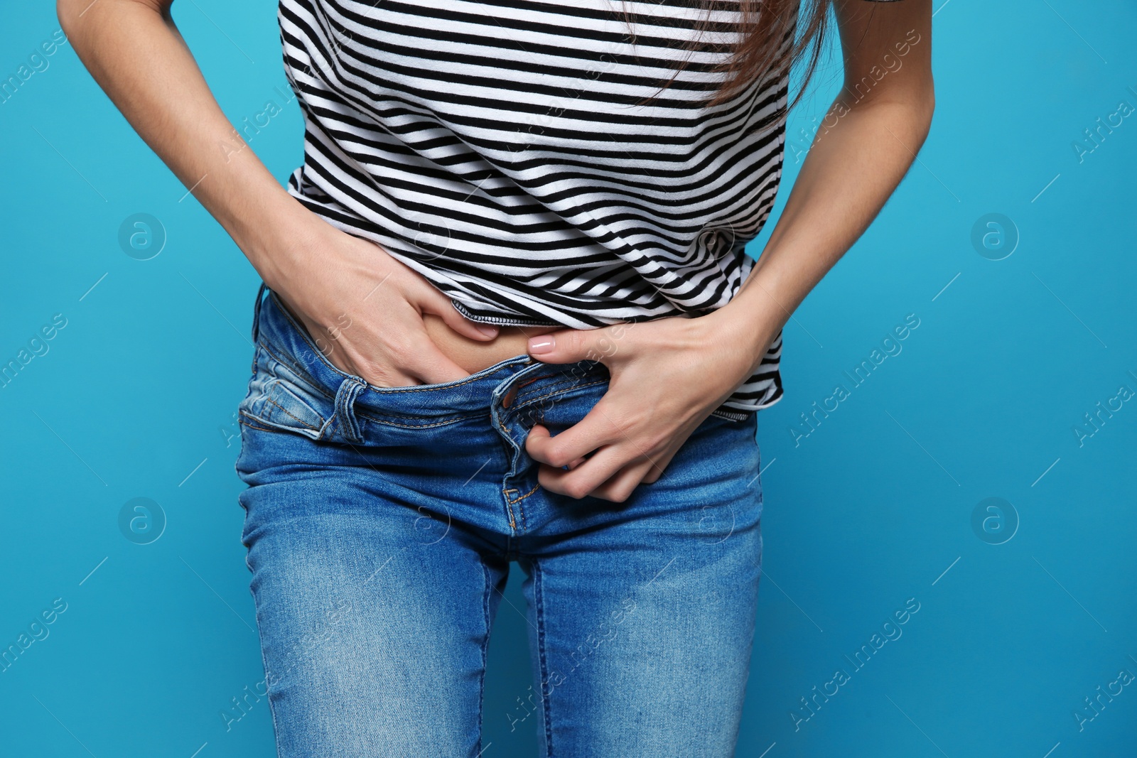 Photo of Woman scratching crotch on color background, closeup. Annoying itch